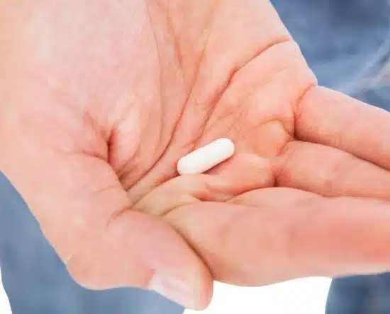 A capsule of NMN Supplement in had of man